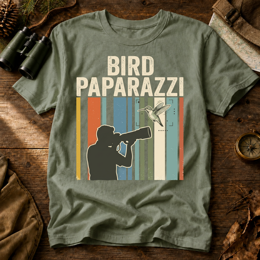 Bird Paparazzi Photography Tee in Bay, centered front design on a birdwatching flat-lay mockup