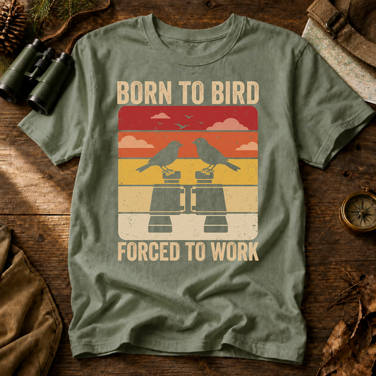 Born to Bird Forced to Work Tee in Bay, centered front design on a birdwatching flat-lay mockup