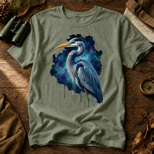 Cosmic Great Blue Heron Tee in Bay, centered front design on a birdwatching flat-lay mockup