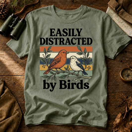 Easily Distracted by Birds Retro Pair Tee in Bay, centered front design on a birdwatching flat-lay mockup