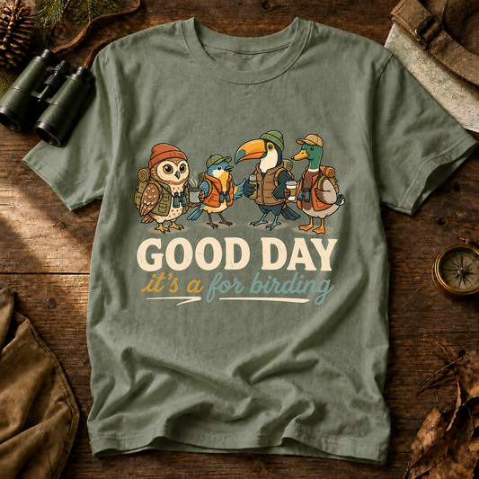 Good Day for Birding Adventure Flock Tee in Bay, centered front design on a birdwatching flat-lay mockup