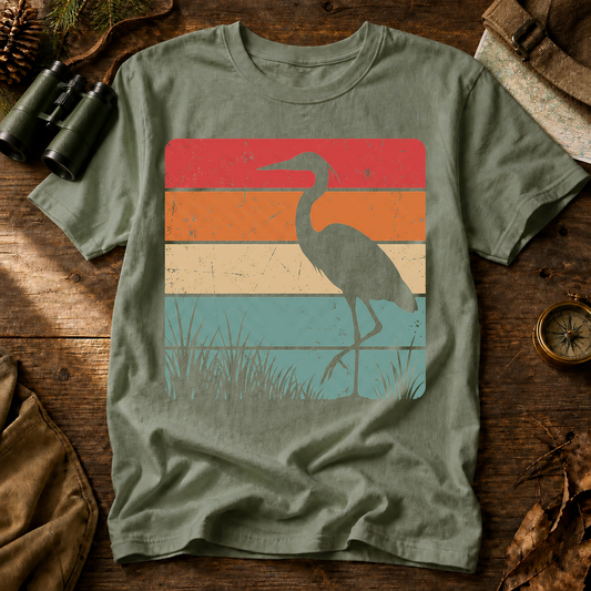 Retro Heron Wetland Tee in Bay, centered front design on a birdwatching flat-lay mockup