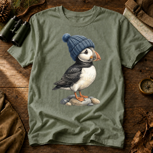 Winter Puffin Beanie Tee in Bay, centered front design on a birdwatching flat-lay mockup