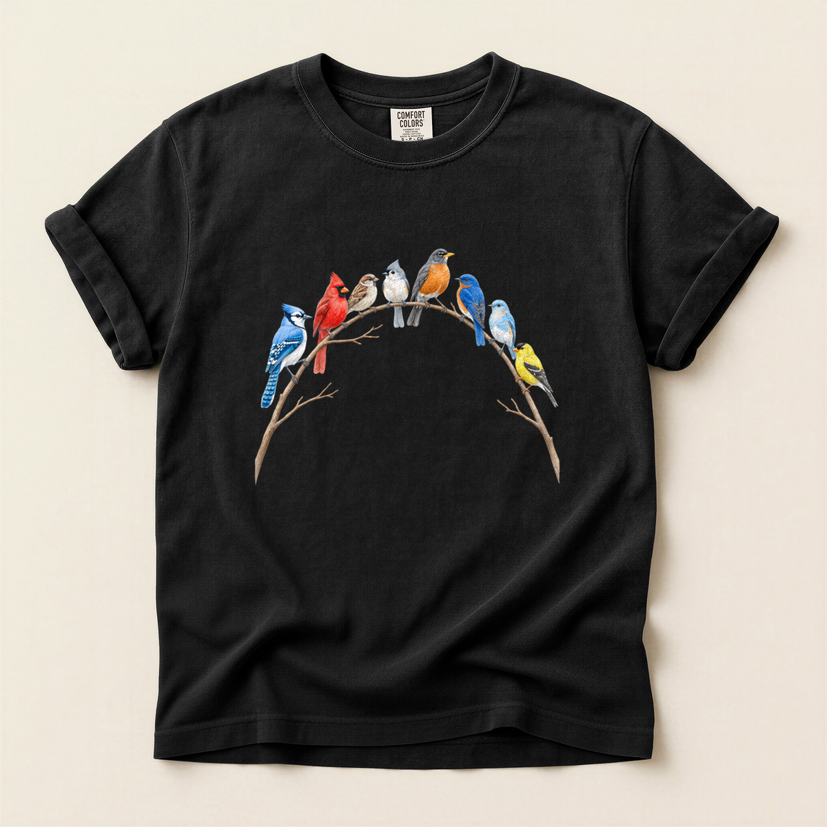 Songbird Branch Arch T-Shirt in Bay laid beside field gear