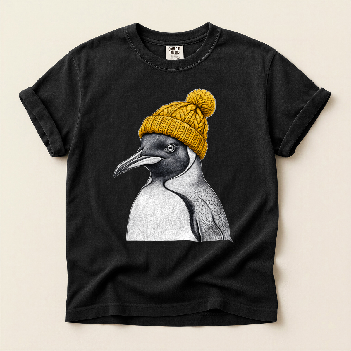 Penguin Yellow Beanie T-Shirt in Bay laid beside field gear