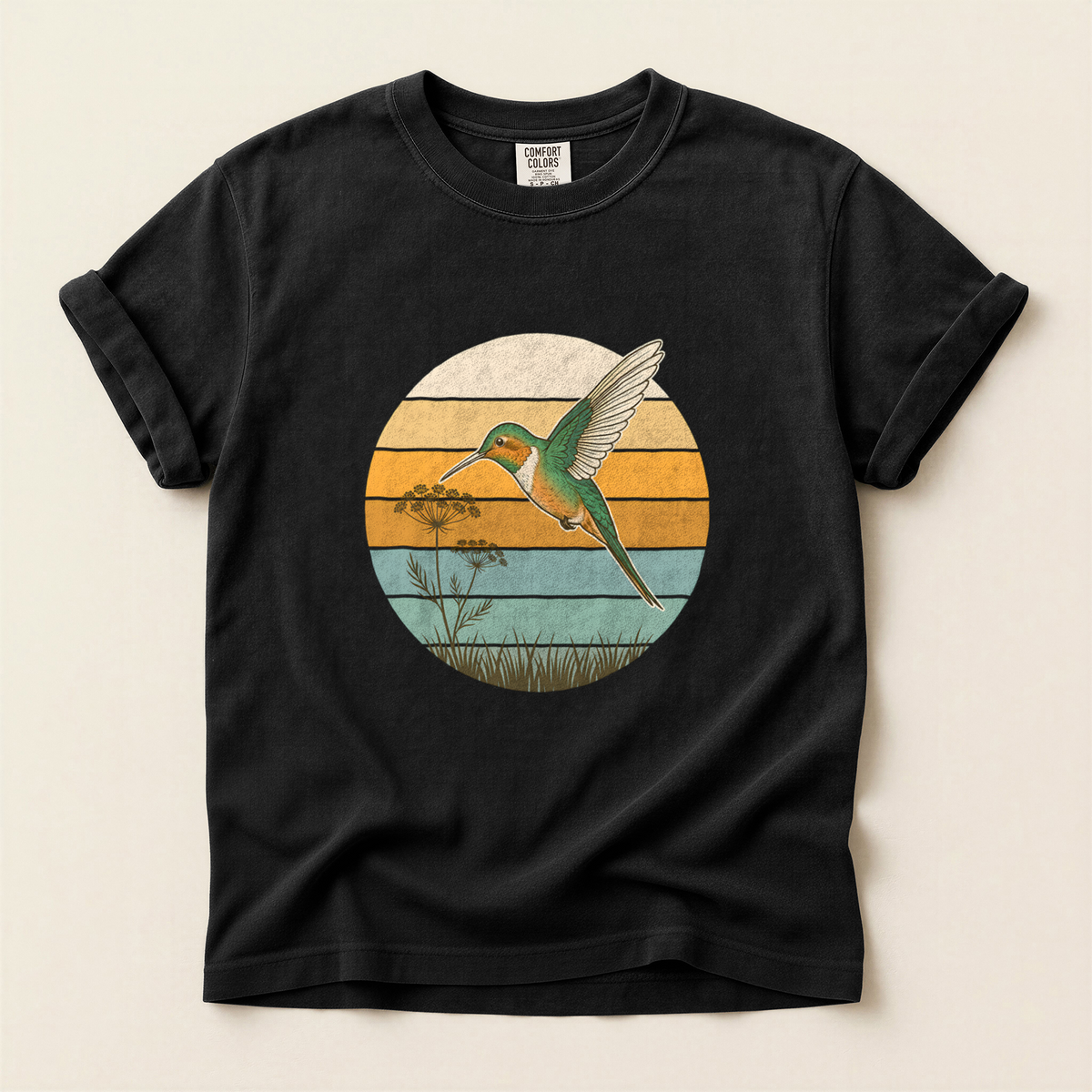 Hummingbird Retro Circle T-Shirt in Bay laid beside field gear