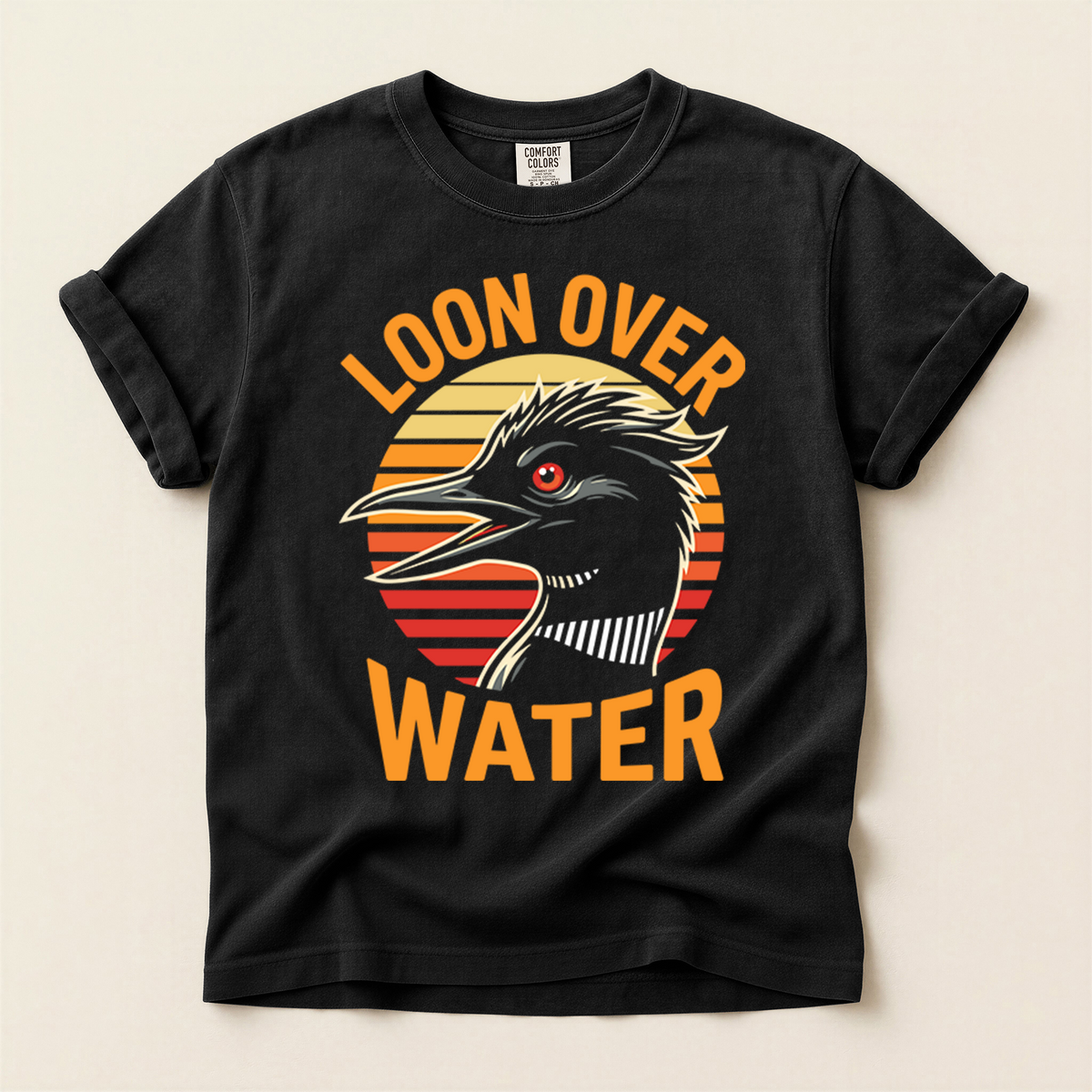 Loon Over Water T-Shirt in Bay laid beside field gear