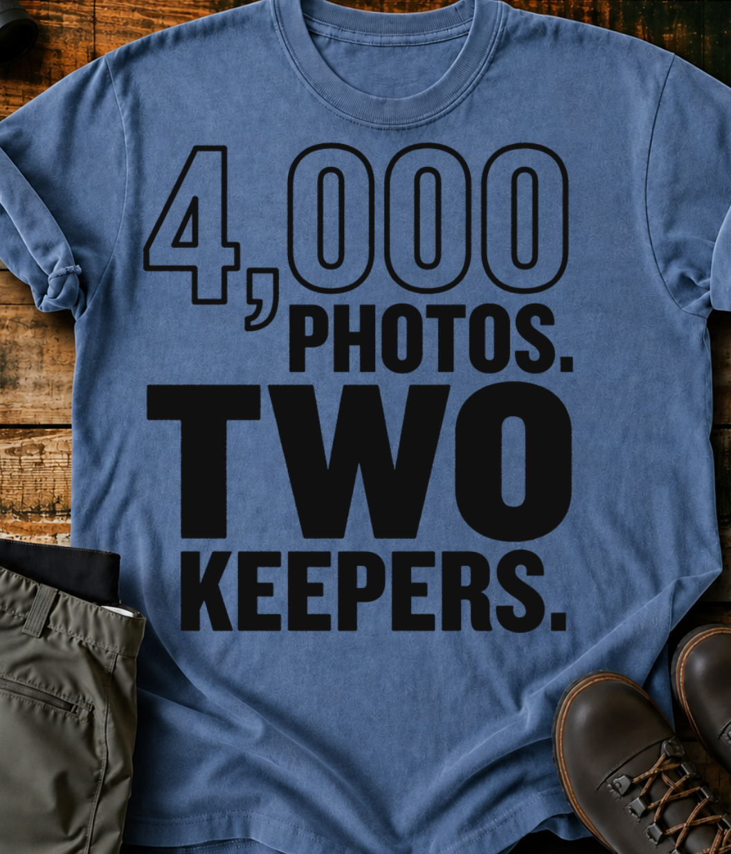 4,000 Photos Two Keepers Bird Photography Tee in Blue Jean, centered front design on a birdwatching flat-lay mockup