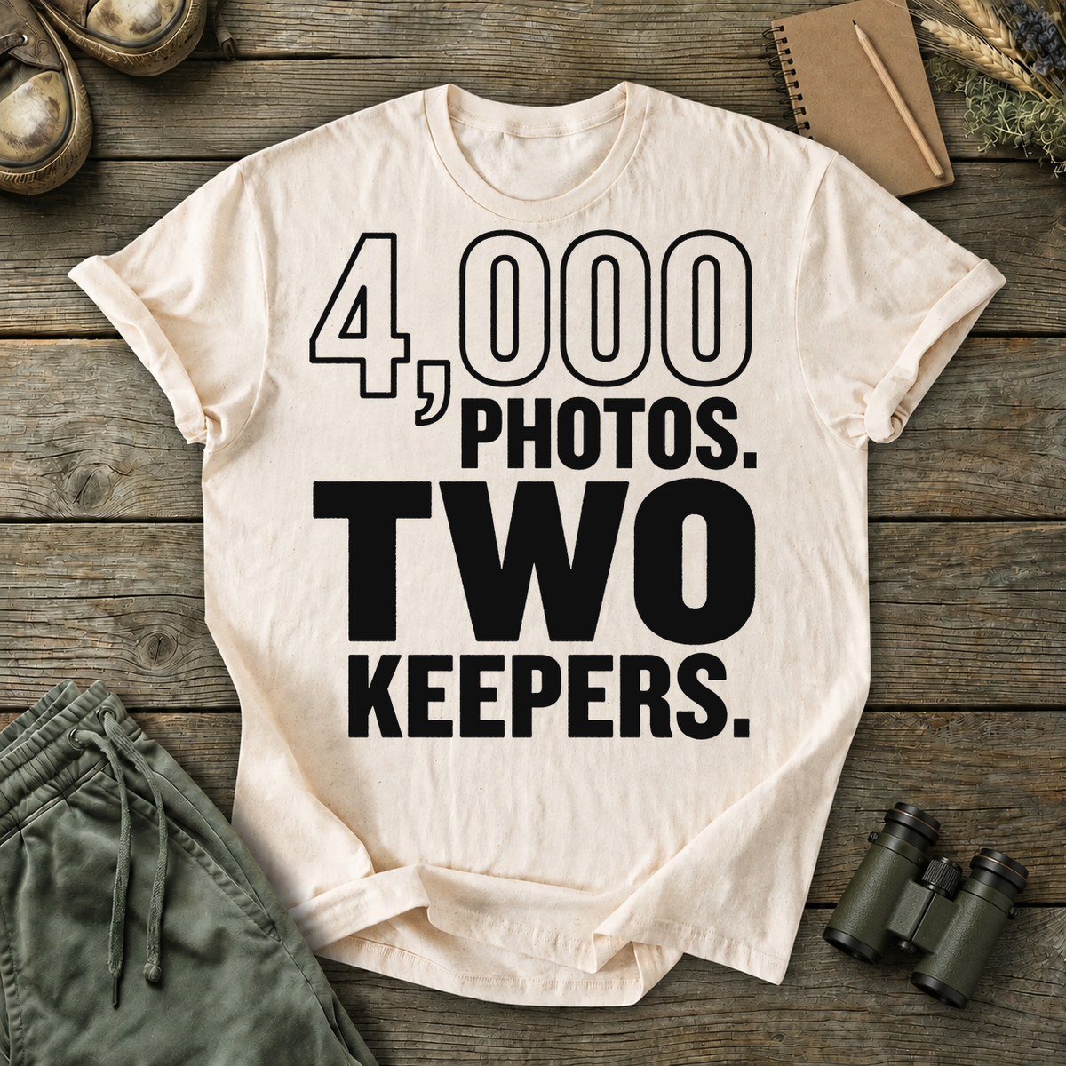 4,000 Photos Two Keepers Bird Photography Tee in Ivory, centered front design on a birdwatching flat-lay mockup