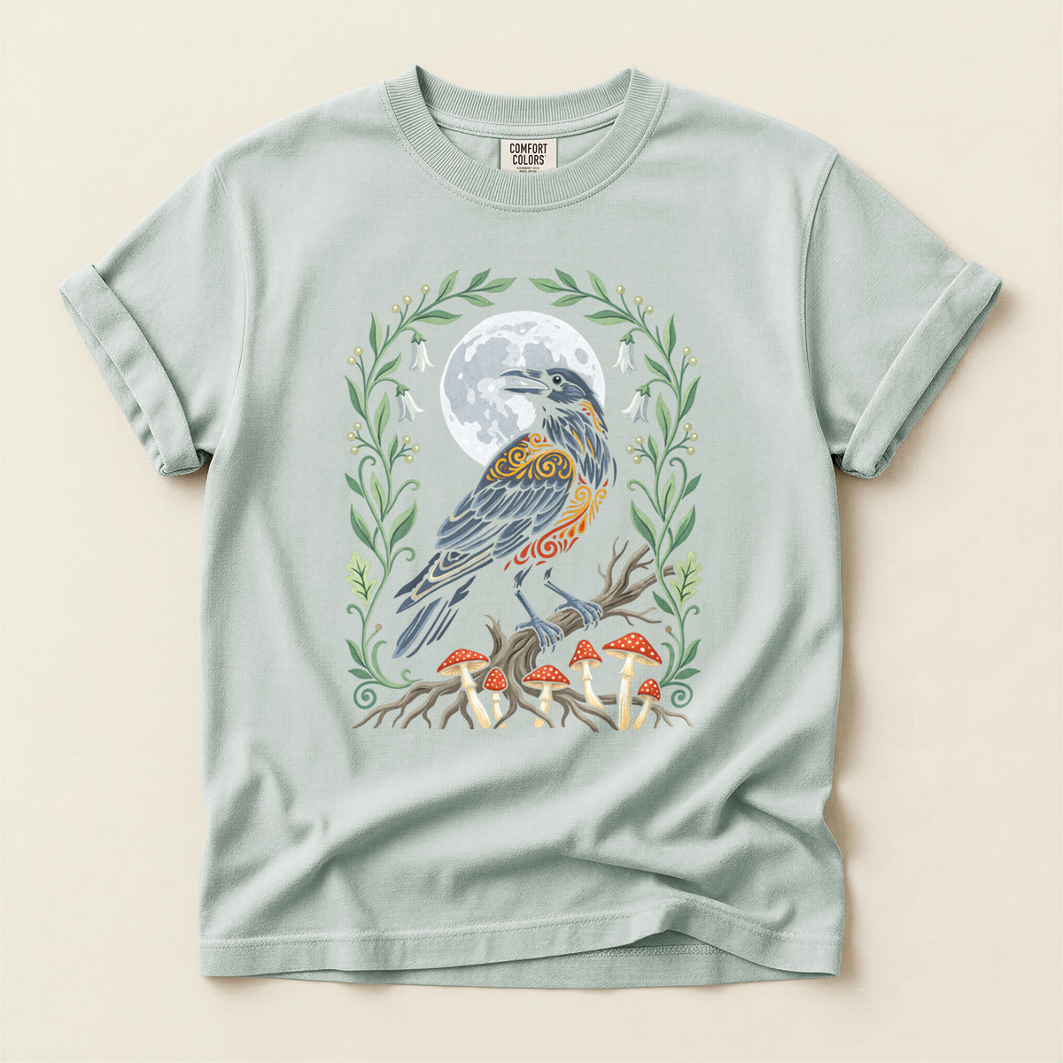 Crow Mushroom Moon T-Shirt in Bay laid beside field gear