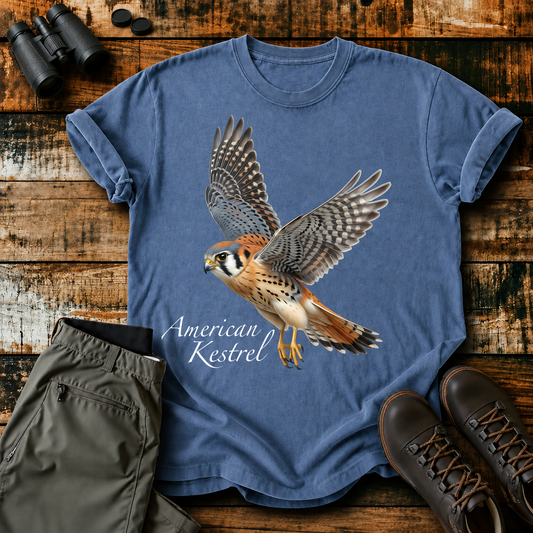 American Kestrel in Flight Tee in Blue Jean, centered front design on a birdwatching flat-lay mockup
