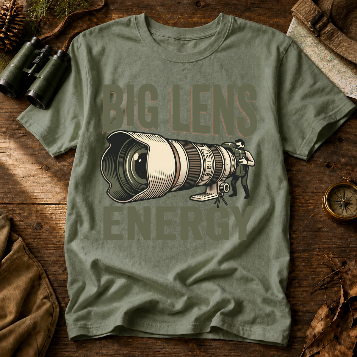 Big Lens Energy Bird Photography Tee in Bay laid beside field gear