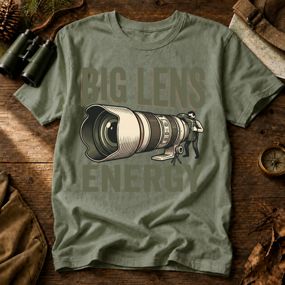 Big Lens Energy Bird Photography Tee in Bay, centered front design on a birdwatching flat-lay mockup
