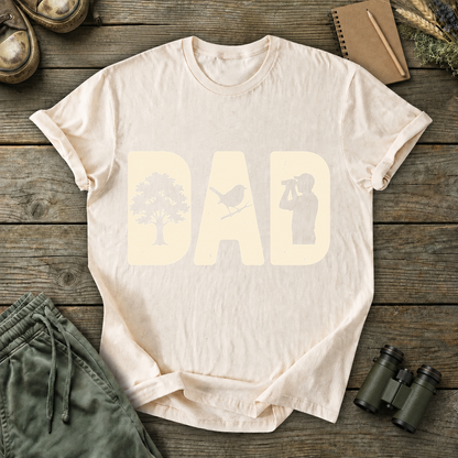 Bird Dad Silhouette Tee in Ivory, centered front design on a birdwatching flat-lay mockup