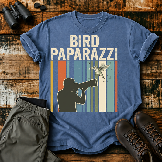 Bird Paparazzi Photography Tee in Blue Jean, centered front design on a birdwatching flat-lay mockup