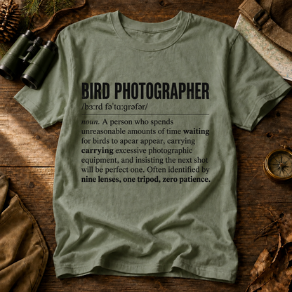 Bird Photographer Definition Tee in Bay, centered front design on a birdwatching flat-lay mockup