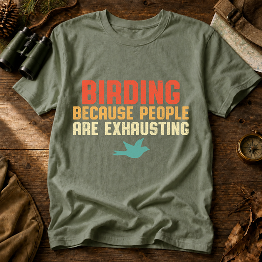 Birding Because People Are Exhausting Tee in Bay, centered front design on a birdwatching flat-lay mockup