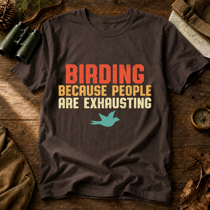 Birding Because People Are Exhausting Tee in Espresso, centered front design on a birdwatching flat-lay mockup