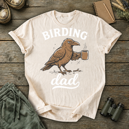 Birding Dad Coffee Bird Tee in Ivory, centered front design on a birdwatching flat-lay mockup
