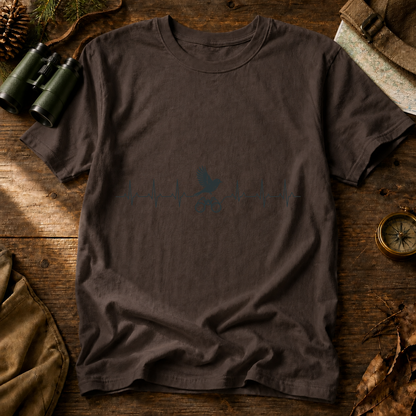 Birding Heartbeat Tee in Espresso, centered front design on a birdwatching flat-lay mockup