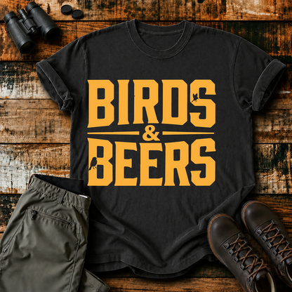 Birds & Beers Tee in Black, centered front design on a birdwatching flat-lay mockup