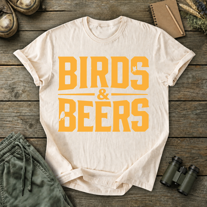 Birds & Beers Tee in Ivory, centered front design on a birdwatching flat-lay mockup