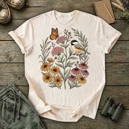 Black-Capped Chickadee Floral Garden Tee in Ivory, centered front design on a birdwatching flat-lay mockup