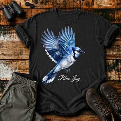 Blue Jay in Flight Tee in Black, centered front design on a birdwatching flat-lay mockup