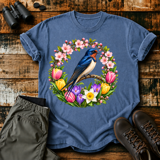 Blue Songbird Spring Wreath Tee in Blue Jean, centered front design on a birdwatching flat-lay mockup