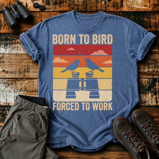 Born to Bird Forced to Work Tee in Blue Jean, centered front design on a birdwatching flat-lay mockup