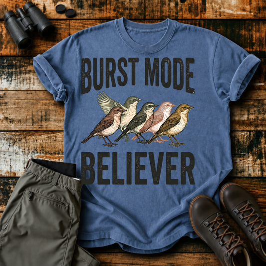 Burst Mode Believer Bird Photography Tee in Blue Jean, centered front design on a birdwatching flat-lay mockup