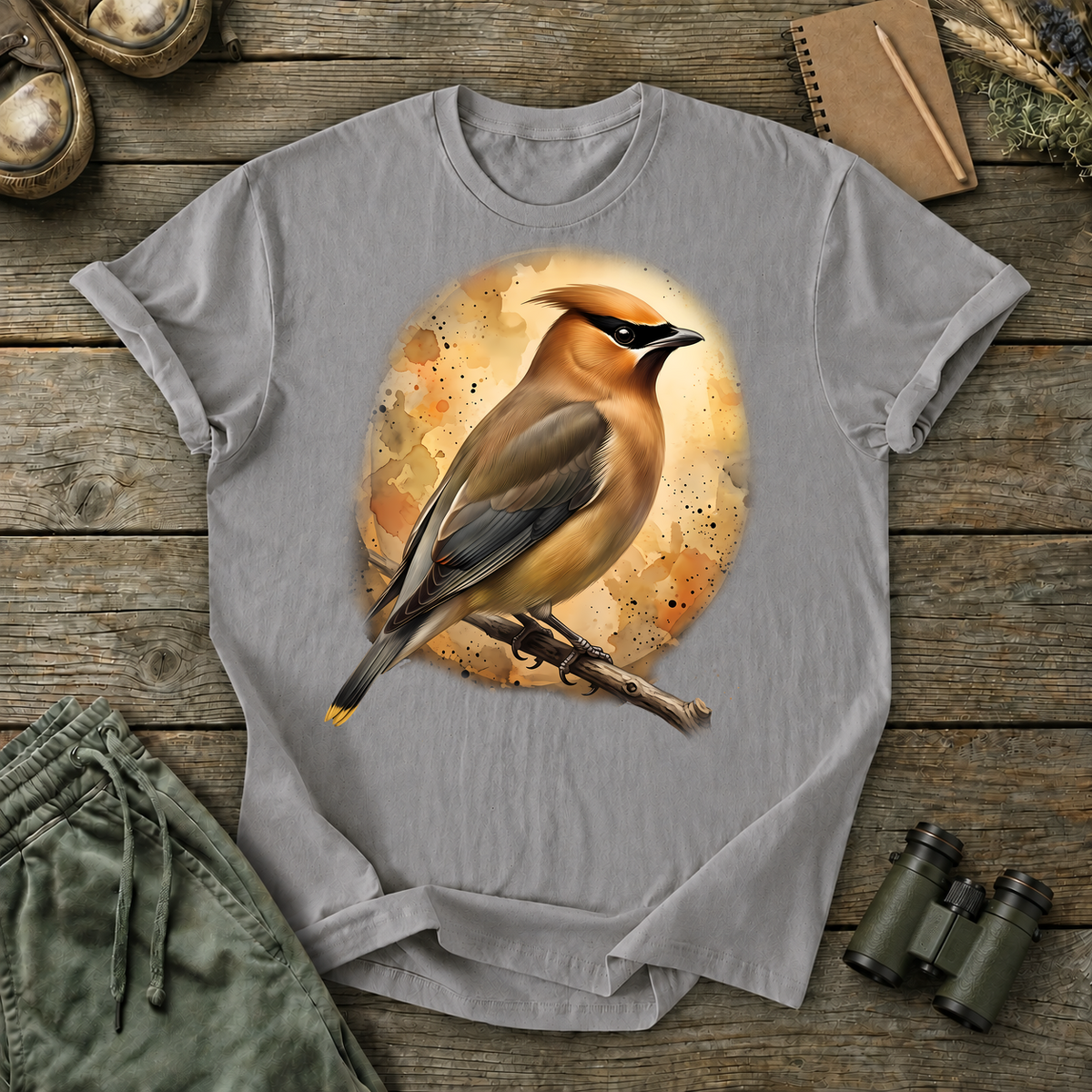 Cedar Waxwing Watercolor Portrait Tee in Grey, centered front design on a birdwatching flat-lay mockup
