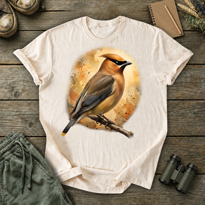 Cedar Waxwing Watercolor Portrait Tee in Ivory, centered front design on a birdwatching flat-lay mockup