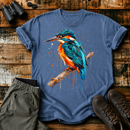 Common Kingfisher Watercolor Tee in Blue Jean, centered front design on a birdwatching flat-lay mockup