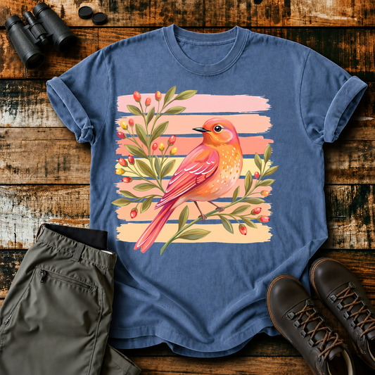 Coral Songbird Berries Tee in Blue Jean, centered front design on a birdwatching flat-lay mockup