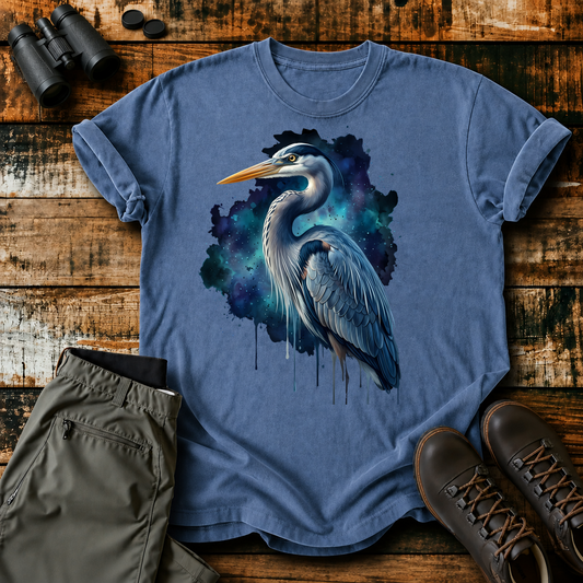 Cosmic Great Blue Heron Tee in Blue Jean, centered front design on a birdwatching flat-lay mockup