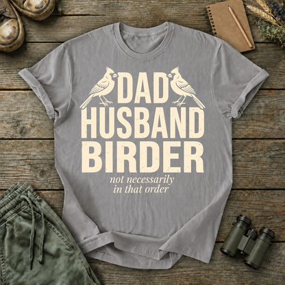 Dad Husband Birder Tee in Grey, centered front design on a birdwatching flat-lay mockup