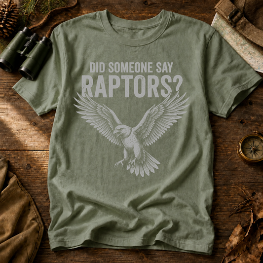 Did Someone Say Raptors Tee in Bay, centered front design on a birdwatching flat-lay mockup