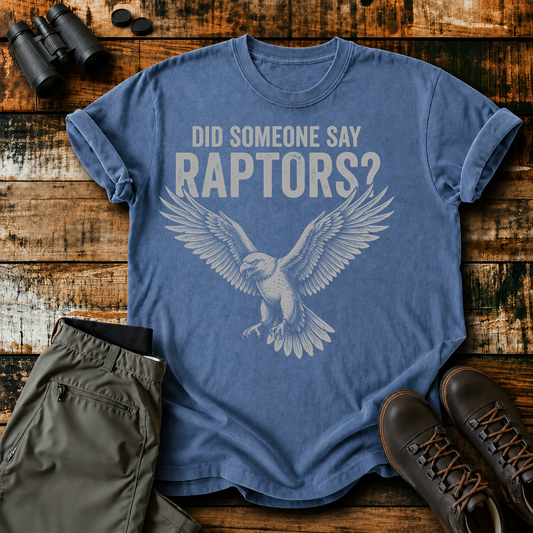 Did Someone Say Raptors Tee in Blue Jean, centered front design on a birdwatching flat-lay mockup