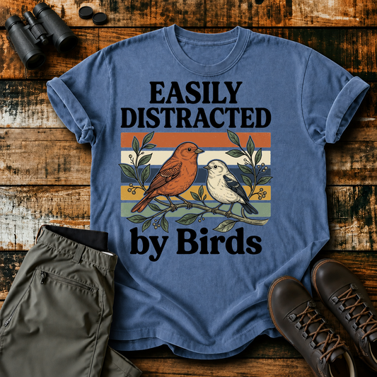 Easily Distracted by Birds Retro Pair Tee in Blue Jean, centered front design on a birdwatching flat-lay mockup