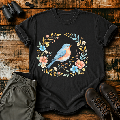 Eastern Bluebird Floral Wreath Tee in Black, centered front design on a birdwatching flat-lay mockup