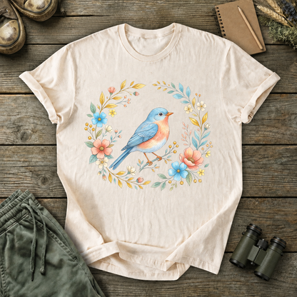 Eastern Bluebird Floral Wreath Tee in Ivory, centered front design on a birdwatching flat-lay mockup