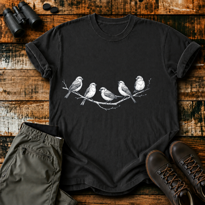 Five Birds on a Branch Tee in Black, centered front design on a birdwatching flat-lay mockup