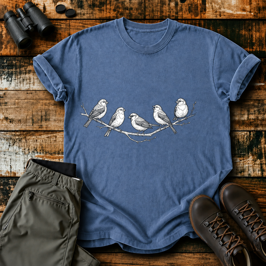 Five Birds on a Branch Tee in Blue Jean, centered front design on a birdwatching flat-lay mockup