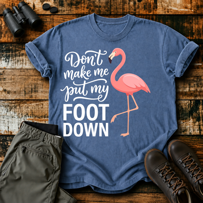 Flamingo Foot Down Tee in Blue Jean, centered front design on a birdwatching flat-lay mockup