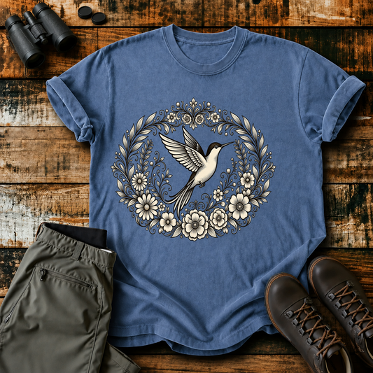 Floral Hummingbird Wreath Tee in Blue Jean, centered front design on a birdwatching flat-lay mockup