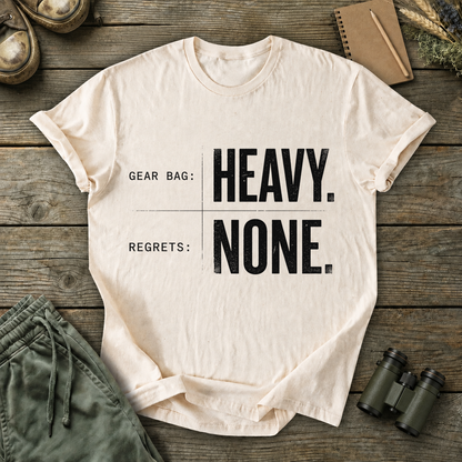 Gear Bag Heavy Regrets None Tee in Ivory, centered front design on a birdwatching flat-lay mockup
