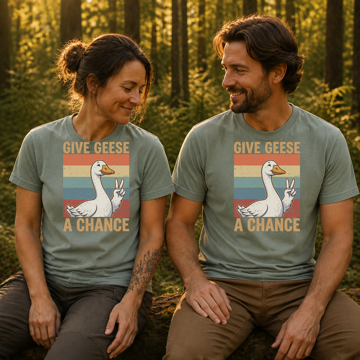 Female and male models wearing the Give Geese a Chance Tee in Bay, with the artwork centered on both shirts