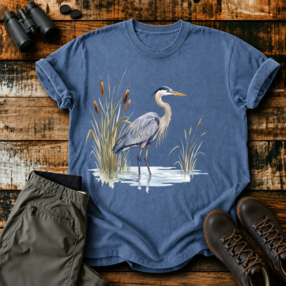 Great Blue Heron Wetland Watercolor Tee in Blue Jean, centered front design on a birdwatching flat-lay mockup