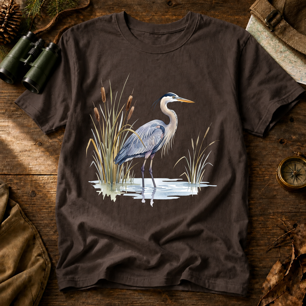 Great Blue Heron Wetland Watercolor Tee in Espresso, centered front design on a birdwatching flat-lay mockup